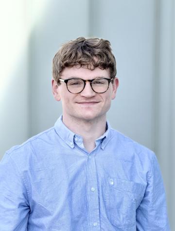 Image of Sam in blue shirt.